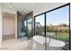 Spa-like bathroom with a soaking tub, glass shower, and backyard views at 6921 N Joshua Tree Ct, Paradise Valley, AZ 85253