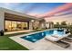 Luxury backyard oasis featuring a large pool and lounge chairs at 6921 N Joshua Tree Ct, Paradise Valley, AZ 85253