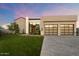 Modern home with two-car garage and landscaped lawn at 6921 N Joshua Tree Ct, Paradise Valley, AZ 85253
