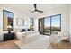 Spacious main bedroom with large windows, plush bedding, and access to backyard at 6921 N Joshua Tree Ct, Paradise Valley, AZ 85253