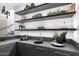 Modern wet bar with sleek cabinetry and floating shelves at 6921 N Joshua Tree Ct, Paradise Valley, AZ 85253