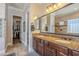 Double vanity bathroom with granite countertops and a large mirror, offering ample space at 3414 E Virgil Dr, Gilbert, AZ 85298