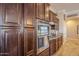 Dark wood cabinetry and stainless steel appliances complete this kitchen at 3414 E Virgil Dr, Gilbert, AZ 85298