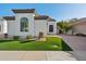 White stucco home with landscaped lawn and driveway at 8133 E Cortez Dr, Scottsdale, AZ 85260