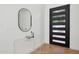 Modern entryway with black door and contemporary decor at 8133 E Cortez Dr, Scottsdale, AZ 85260