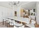 Modern dining room with white table and access to kitchen at 8133 E Cortez Dr, Scottsdale, AZ 85260