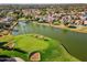 Aerial view of a golf course green next to a lake at 8133 E Cortez Dr, Scottsdale, AZ 85260