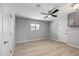 Simple bedroom with ceiling fan, wood-look flooring, and neutral walls at 12502 W Limewood Dr, Sun City West, AZ 85375