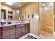 Bathroom with double vanity, shower, and natural light at 5802 E Cholla Ln, Paradise Valley, AZ 85253