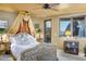 Bright bedroom with a canopy bed and access to private balcony at 5802 E Cholla Ln, Paradise Valley, AZ 85253