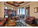 Home office features built-in shelving, large windows, and a comfortable seating area at 5802 E Cholla Ln, Paradise Valley, AZ 85253