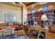 Spacious home office with large desk, comfortable seating, and built-in shelves at 5802 E Cholla Ln, Paradise Valley, AZ 85253