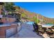 Outdoor kitchen with built-in grill and seating area at 5802 E Cholla Ln, Paradise Valley, AZ 85253