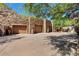 Three-car garage with stone exterior and mountain backdrop at 5802 E Cholla Ln, Paradise Valley, AZ 85253