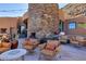 Stone patio with fireplace and comfortable seating at 5802 E Cholla Ln, Paradise Valley, AZ 85253