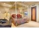 Bedroom with four-poster bed and private sitting area at 5802 E Cholla Ln, Paradise Valley, AZ 85253