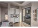 Convenient wet bar with white cabinets, a mini-fridge, and access to a patio at 10119 E Horizon Dr, Scottsdale, AZ 85262
