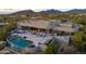 Aerial view of a luxurious home with a large pool and expansive patio at 10119 E Horizon Dr, Scottsdale, AZ 85262