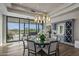 Elegant dining room features a large table, modern chandelier, and access to backyard at 10119 E Horizon Dr, Scottsdale, AZ 85262