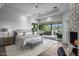 Spacious main bedroom with fireplace, large windows, and access to the patio at 10119 E Horizon Dr, Scottsdale, AZ 85262