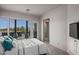 Comfortable guest bedroom with outdoor access and a view of the backyard at 10119 E Horizon Dr, Scottsdale, AZ 85262