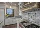 Stylish kitchen with white cabinets, marble countertops, and a view of the landscape at 10119 E Horizon Dr, Scottsdale, AZ 85262