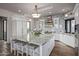 Gourmet kitchen with white cabinetry, marble countertops, and high-end appliances at 10119 E Horizon Dr, Scottsdale, AZ 85262