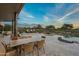 Stunning backyard with a pool, patio furniture, and a beautiful sunset view at 10119 E Horizon Dr, Scottsdale, AZ 85262