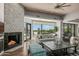 Bright living room with a stunning fireplace and large windows offering scenic views at 10119 E Horizon Dr, Scottsdale, AZ 85262