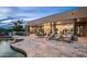 Relaxing pool and patio area with lounge chairs and fire pit at 10119 E Horizon Dr, Scottsdale, AZ 85262