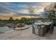 Modern outdoor kitchen with grill and bar seating at 10119 E Horizon Dr, Scottsdale, AZ 85262