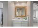 Modern bathroom with a white vanity and an ornate mirror at 10119 E Horizon Dr, Scottsdale, AZ 85262