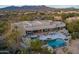 Aerial view showcasing a large home, pool, and mountain views at 10119 E Horizon Dr, Scottsdale, AZ 85262
