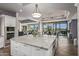 Large kitchen island with marble countertops and a view into the living area at 10119 E Horizon Dr, Scottsdale, AZ 85262