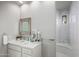Clean bathroom with marble vanity, a walk-in shower, and a rustic mirror at 10119 E Horizon Dr, Scottsdale, AZ 85262