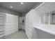 Spacious walk-in closet with ample shelving and drawer space at 10119 E Horizon Dr, Scottsdale, AZ 85262