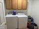 Laundry room with washer, dryer, and overhead cabinets at 33202 W Ardmore Rd, Tonopah, AZ 85354