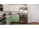 Well-equipped kitchen with stainless steel fridge and green cabinetry at 1234 E Washington Ave, Gilbert, AZ 85234