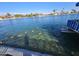 Ducks swimming in a lake with a water fountain and waterfront homes at 13869 N Buccaneer Way, Sun City, AZ 85351