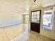 Living room with light laminate wood flooring and door to exterior at 1451 N Spencer --, Mesa, AZ 85203