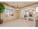Spacious dining room with hardwood floors, view into living room with fireplace, and large windows at 2717 W Nighthawk Way, Phoenix, AZ 85045