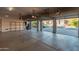 Three-car garage with open doors showing a view of the street at 2717 W Nighthawk Way, Phoenix, AZ 85045