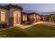Well-lit home exterior at night with lush landscaping at 2717 W Nighthawk Way, Phoenix, AZ 85045