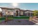 Luxury home exterior with a three-car garage and manicured lawn at 2717 W Nighthawk Way, Phoenix, AZ 85045