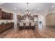 Gourmet kitchen with granite countertops, dark wood cabinets, and stainless steel appliances at 2717 W Nighthawk Way, Phoenix, AZ 85045