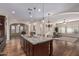 Spacious kitchen with granite island, hardwood floors, and views into the living room at 2717 W Nighthawk Way, Phoenix, AZ 85045
