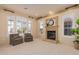 Relaxing living room with fireplace and large windows at 2717 W Nighthawk Way, Phoenix, AZ 85045