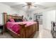 Spacious bedroom with a large wooden bed frame at 3433 W Poinsettia Dr, Phoenix, AZ 85029