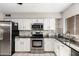 Modern kitchen with stainless steel appliances and dark countertops at 3433 W Poinsettia Dr, Phoenix, AZ 85029