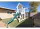 Wooden playset with slide and climbing wall in backyard at 3433 W Poinsettia Dr, Phoenix, AZ 85029